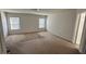 Spacious bedroom with a neutral carpet and two windows at 2548 Sweet Birch Ct, Gastonia, NC 28054