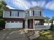 Charming two-story home featuring a covered front porch and a two-car garage at 2548 Sweet Birch Ct, Gastonia, NC 28054