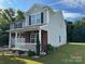 A corner view of a two-story home featuring gray siding and a brick facade at 2548 Sweet Birch Ct, Gastonia, NC 28054