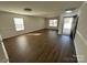 The living room with laminate flooring and a front door view at 2548 Sweet Birch Ct, Gastonia, NC 28054