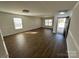 Bright living room featuring laminate flooring and a front door at 2548 Sweet Birch Ct, Gastonia, NC 28054