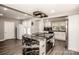 Open-concept kitchen with stainless steel appliances, kitchen island with cooking surface, and ample storage at 60 Hunter Bridge Rd, Stony Point, NC 28678