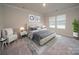 Serene main bedroom with tufted headboard, neutral tones, and ample natural light, creating a relaxing retreat at 158 Shepherds Landing Dr, Mooresville, NC 28115