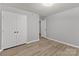 Bedroom with double door closet and wood-look flooring at 140 Lake Concord Ne Rd # D9, Concord, NC 28025