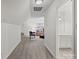 View of the bright living room featuring wood floors, recessed lighting, and open access to the bathroom at 1823 Southridge Dr, Belmont, NC 28012