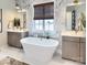 Luxurious bathroom featuring a soaking tub, dual vanities, marble accents and a window at 837 Lake Forest Dr # Nottingham, Belmont, NC 28012