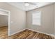 Bright bedroom featuring wood-look floors and a window with blinds at 1528 28Th Street Se Pl, Hickory, NC 28602