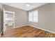 Spacious bedroom with wood-look flooring and view of kitchen at 1528 28Th Street Se Pl, Hickory, NC 28602