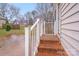 Outdoor space featuring a brick steps leading to a covered porch, complete with white railings and natural surroundings at 2515 Winterfield Dr, Gastonia, NC 28056