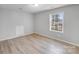 Bright bedroom featuring wood-look flooring and large window at 2515 Winterfield Dr, Gastonia, NC 28056