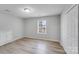 Bedroom featuring wood-look flooring, large window, and closet at 2515 Winterfield Dr, Gastonia, NC 28056