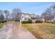 Charming two-story home featuring a covered front porch, lush landscaping, and an expansive front lawn at 2515 Winterfield Dr, Gastonia, NC 28056