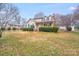 Inviting two-story home with a well-manicured front yard, classic design elements, and lush green shrubbery at 2515 Winterfield Dr, Gastonia, NC 28056