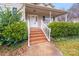 Welcoming front porch with brick steps, white railings, and manicured bushes enhancing the curb appeal of the home at 2515 Winterfield Dr, Gastonia, NC 28056