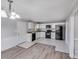 Well-lit kitchen with white cabinets, black appliances, and tile flooring next to dining area at 2515 Winterfield Dr, Gastonia, NC 28056