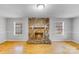 Bright living room with a striking stone fireplace, and large windows, on light hardwood floors at 2515 Winterfield Dr, Gastonia, NC 28056