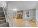 Living room showcasing a stone fireplace, staircase, and light hardwood floors at 2515 Winterfield Dr, Gastonia, NC 28056