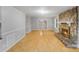 Spacious living room highlighting hardwood floors, a stone fireplace, and a wall-mounted air conditioner at 2515 Winterfield Dr, Gastonia, NC 28056