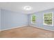 Simple bedroom with carpet, neutral walls, and two windows at 7223 Meyer Rd, Fort Mill, SC 29715