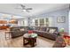 Living room with sectional sofa, hardwood floors, and open concept to kitchen at 7223 Meyer Rd, Fort Mill, SC 29715