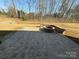 Landscaped backyard with a stone patio, built-in seating, and a fire pit perfect for entertaining at 3229 Mcharney Dr # 30, Harrisburg, NC 28075