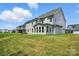 Spacious backyard featuring lush green grass, and an exterior view of a two-story residential home at 3229 Mcharney Dr # 30, Harrisburg, NC 28075