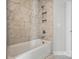 Elegant bathroom featuring a tub with marble tile surround and a convenient shower niche at 3229 Mcharney Dr # 30, Harrisburg, NC 28075