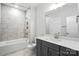 Bathroom with shower over tub, gray vanity, modern fixtures and marble tile at 3229 Mcharney Dr # 30, Harrisburg, NC 28075