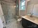 Modern bathroom featuring a marble tiled shower with glass door and seat, plus sleek vanity and fixtures at 3229 Mcharney Dr # 30, Harrisburg, NC 28075