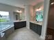 Modern bathroom featuring dual vanities, a soaking tub, and tile flooring offers a luxurious spa-like experience at 3229 Mcharney Dr # 30, Harrisburg, NC 28075