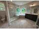 Bright bathroom features a glass-enclosed shower, a garden tub, and stylish gray vanity at 3229 Mcharney Dr # 30, Harrisburg, NC 28075