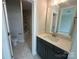 Well-lit bathroom featuring tile flooring, a modern vanity, and a shower with a built-in niche at 3229 Mcharney Dr # 30, Harrisburg, NC 28075