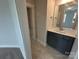 Bright bathroom featuring stylish vanity, mirror, and a glimpse of the shower, connecting to another room at 3229 Mcharney Dr # 30, Harrisburg, NC 28075
