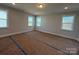 Spacious bedroom filled with natural light from multiple windows offers a tranquil ambiance at 3229 Mcharney Dr # 30, Harrisburg, NC 28075