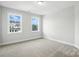 Bedroom with ample natural light and neutral carpeting providing a serene space at 3229 Mcharney Dr # 30, Harrisburg, NC 28075