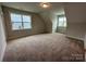 Spacious bedroom with neutral carpet, two large windows, and ample natural light offers comfort at 3229 Mcharney Dr # 30, Harrisburg, NC 28075