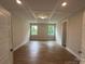 Open bedroom with hardwood flooring, a coffered ceiling, and natural light from the windows at 3229 Mcharney Dr # 30, Harrisburg, NC 28075