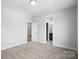 Expansive bedroom with plush carpet, neutral walls, and doorways leading to additional rooms at 3229 Mcharney Dr # 30, Harrisburg, NC 28075