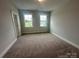Bedroom featuring plush carpet, neutral paint and natural light through the windows at 3229 Mcharney Dr # 30, Harrisburg, NC 28075