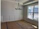 Formal dining room with elegant chandelier, wainscoting, and large window that offers natural light at 3229 Mcharney Dr # 30, Harrisburg, NC 28075