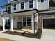 Inviting front porch featuring stone accents, white columns, and manicured landscaping leading to the main door at 3229 Mcharney Dr # 30, Harrisburg, NC 28075