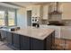 Modern kitchen island featuring a light countertop, dark cabinetry, and stainless steel appliances at 3229 Mcharney Dr # 30, Harrisburg, NC 28075