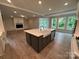 Gourmet kitchen with central island, stainless steel appliances, and an open layout to the living area at 3229 Mcharney Dr # 30, Harrisburg, NC 28075