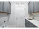 Well-lit laundry room features white cabinets and a sink for convenience at 3229 Mcharney Dr # 30, Harrisburg, NC 28075