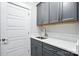 Laundry room boasts quartz counters, gray cabinets and modern design at 3229 Mcharney Dr # 30, Harrisburg, NC 28075