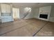 Spacious living room featuring a fireplace, staircase, and views into the kitchen and entryway at 3229 Mcharney Dr # 30, Harrisburg, NC 28075