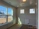 Bright living room with large windows, hardwood floors, and decorative trim details, offering a versatile space at 3229 Mcharney Dr # 30, Harrisburg, NC 28075