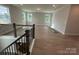 Spacious loft area with iron railing, offering a view of the lower level and great natural light at 3229 Mcharney Dr # 30, Harrisburg, NC 28075