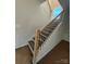 Bright staircase features black metal balusters, wooden handrail, and natural light at 3229 Mcharney Dr # 30, Harrisburg, NC 28075