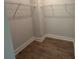Walk-in closet with wood-look floors and white wire shelving is ready for ample storage at 3229 Mcharney Dr # 30, Harrisburg, NC 28075